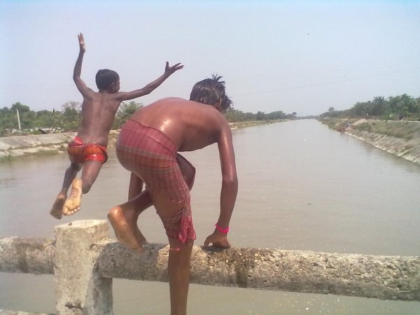 Children Jumping onto the River