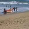 Fishermen with boat on Mamallapuram beach