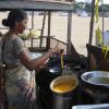 A woman making fried bajji in snacks stall at Besant Nagar beach in Chennai...