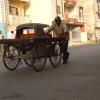 Worker pulling Hand Cart