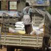 Workers unloading rice bags in a provisional store in Selaiyur