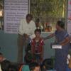 Kid patiently waiting to receive his Cup during Prize Distribution function in Seshadri School