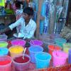 A boy selling coloured powder at Big market in Pondicherry...