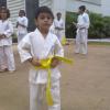 Kid posing after getting his yellow belt
