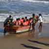 Fishermen push the boat at Mamallapuram beach