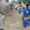 Children sitting on the Nandhi sculpture at Pancha rathas area in Mahabalipuram