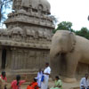 Visitors sitting on the Elephant sculpture at Mamallapuram