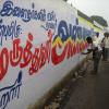 A man paints on the wall at Tambaram in Chennai...