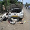 Men repairing the car at Vinayagar street in Velachery, Chennai...
