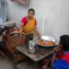 Woman frying Vadas at Chennai Besant Nagar street side...