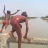 Children Jumping onto the River