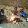 Children sit around a fire to save themselves from Winter Season, Khaupali