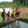 boys  enjoy bath in village canal