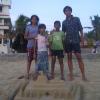 Kids making sand tombs in the beach