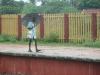 Old man walking cautiously on a rainy day in Panruti platform
